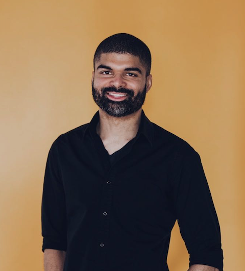 headshot of Jay Hinds with yellow background